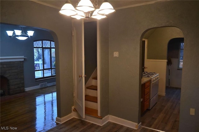 interior space featuring crown molding, dark hardwood / wood-style floors, and an inviting chandelier