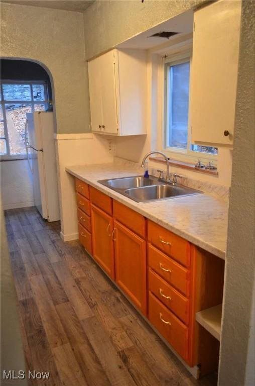 kitchen featuring sink, white fridge, and dark hardwood / wood-style floors