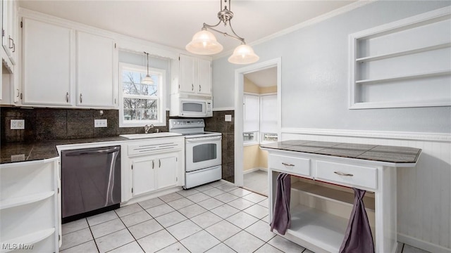 kitchen featuring decorative backsplash, white cabinetry, hanging light fixtures, and white appliances