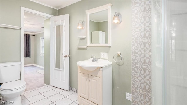 bathroom featuring tile patterned floors, vanity, toilet, and crown molding