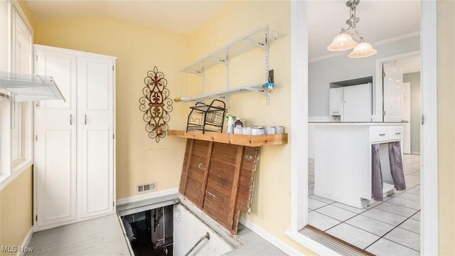 bathroom with lofted ceiling, tile patterned floors, and ornamental molding