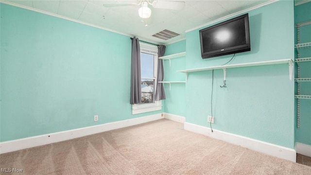 spare room with carpet floors, ceiling fan, and ornamental molding