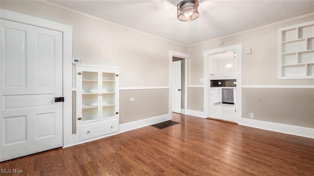 spare room featuring hardwood / wood-style flooring and ornamental molding