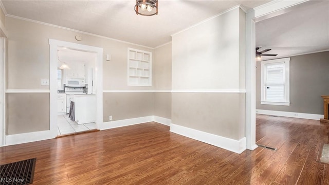 spare room featuring ceiling fan, light hardwood / wood-style floors, and ornamental molding