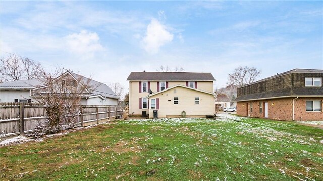 rear view of house with a yard