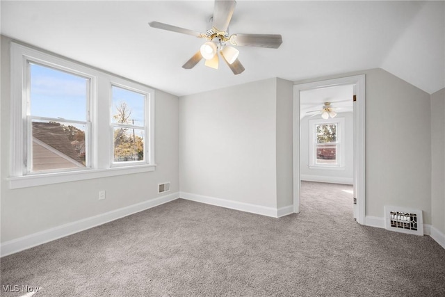 additional living space with ceiling fan, carpet, and vaulted ceiling