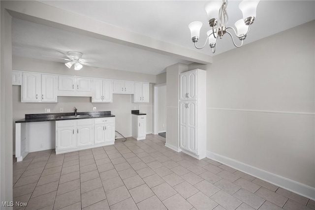 kitchen featuring white cabinetry, sink, pendant lighting, light tile patterned floors, and ceiling fan with notable chandelier