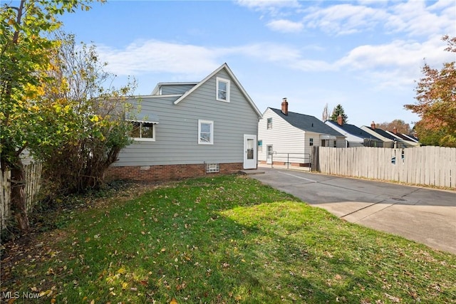 rear view of property featuring a yard