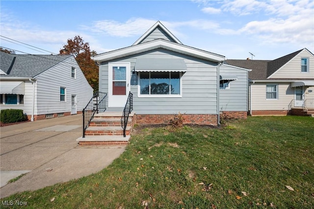 bungalow-style house featuring a front yard