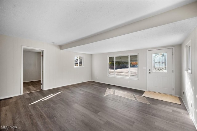 entryway featuring dark hardwood / wood-style flooring and a textured ceiling