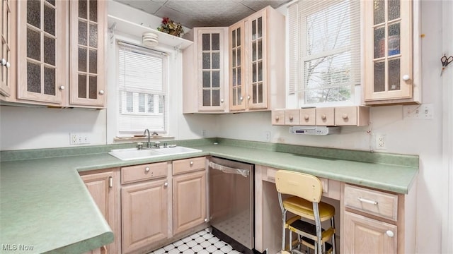 kitchen featuring dishwasher, light brown cabinets, plenty of natural light, and sink