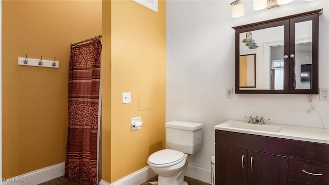 bathroom with vanity, toilet, and curtained shower