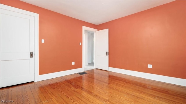 empty room with hardwood / wood-style floors