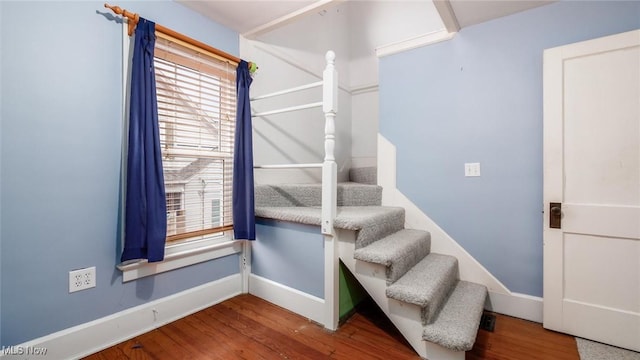 stairs featuring hardwood / wood-style floors