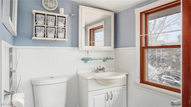 bathroom featuring vanity, toilet, and a wealth of natural light