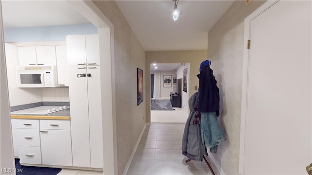 hallway with light tile patterned floors