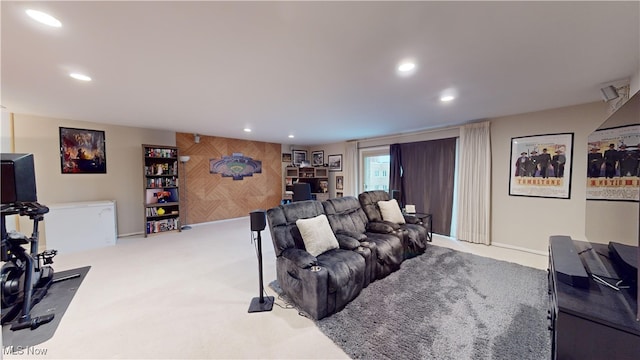 living room featuring light carpet and wooden walls