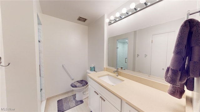 bathroom with a shower with door, vanity, and toilet