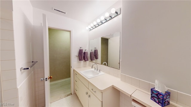 bathroom featuring tile patterned flooring and vanity