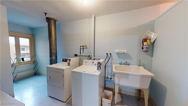 clothes washing area featuring independent washer and dryer