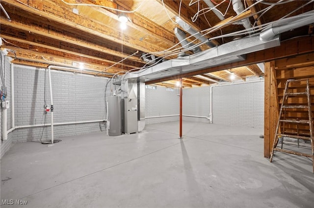 basement featuring brick wall and gas water heater