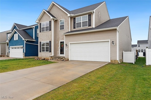 traditional-style home with a garage, fence, a front lawn, and concrete driveway