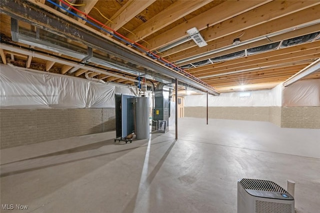 unfinished basement with gas water heater and heating unit