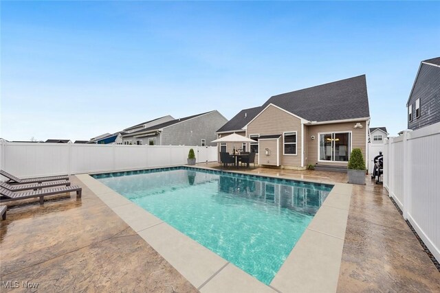 view of swimming pool featuring entry steps, a patio area, a fenced backyard, and a fenced in pool