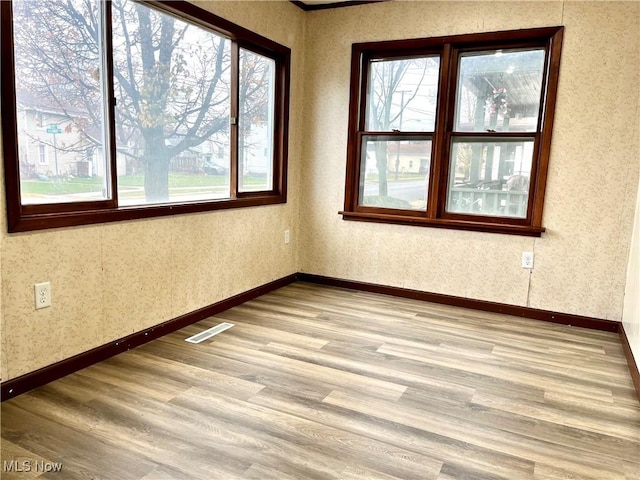 spare room with light wood-type flooring