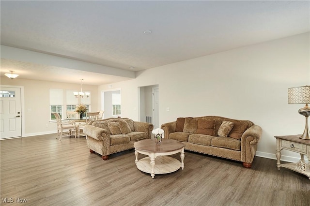 living room featuring hardwood / wood-style flooring and a chandelier