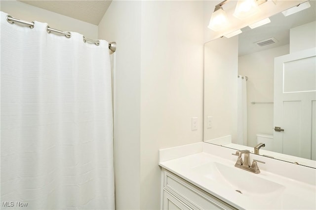 bathroom with vanity and a textured ceiling