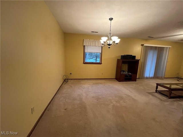 interior space with carpet and an inviting chandelier