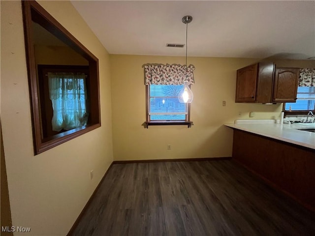 kitchen featuring pendant lighting, dark hardwood / wood-style floors, and sink