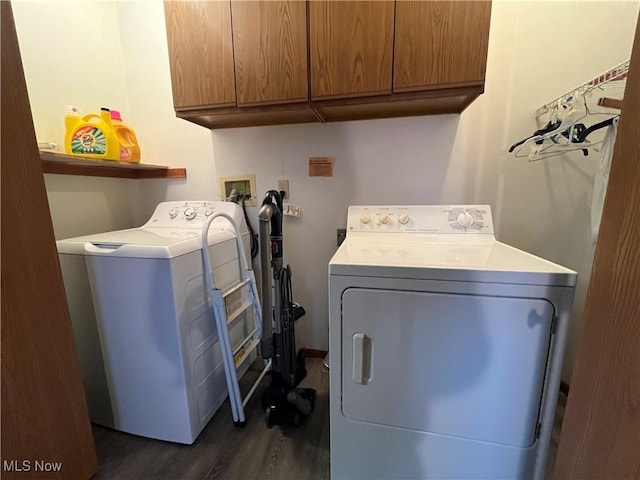 laundry room with cabinets, dark hardwood / wood-style flooring, and separate washer and dryer