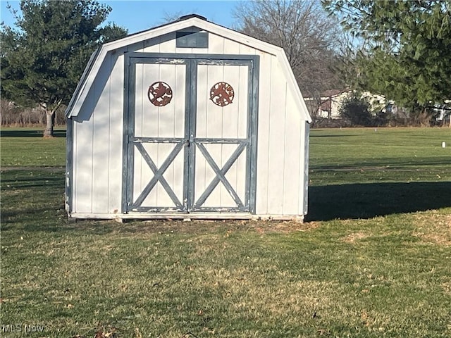 view of outbuilding featuring a lawn