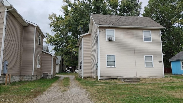 view of side of property with a yard