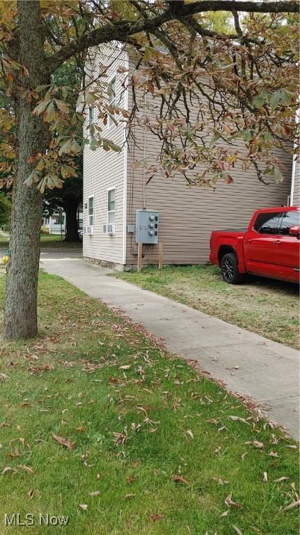 view of side of property with a lawn