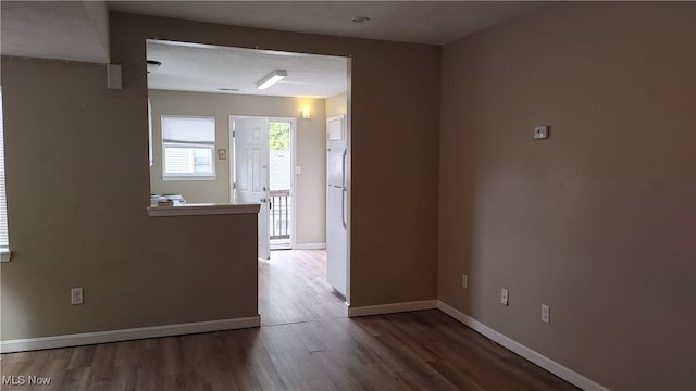 unfurnished room with hardwood / wood-style flooring