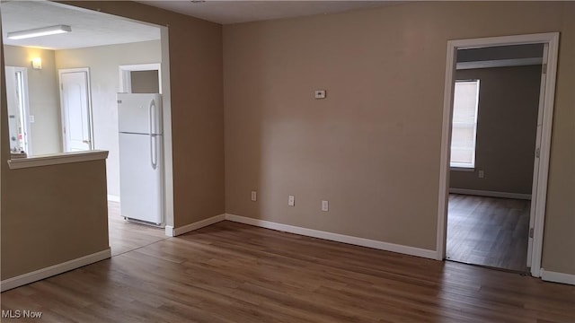 spare room featuring dark hardwood / wood-style floors