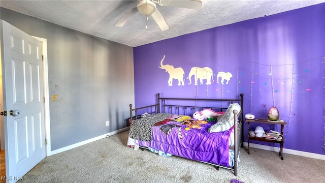 carpeted bedroom with ceiling fan and a textured ceiling