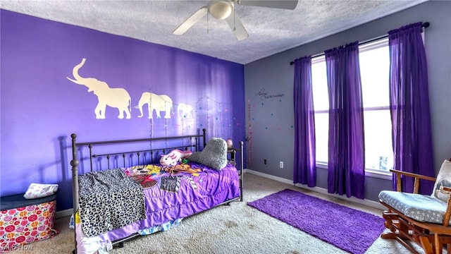 bedroom featuring carpet flooring, ceiling fan, a textured ceiling, and multiple windows