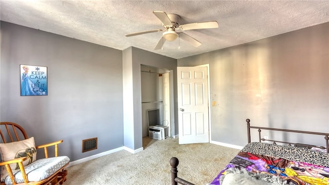 bedroom with carpet flooring, a textured ceiling, and ceiling fan