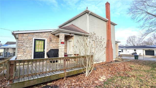 rear view of house featuring a wooden deck