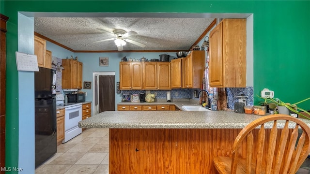 kitchen with kitchen peninsula, backsplash, crown molding, sink, and black appliances