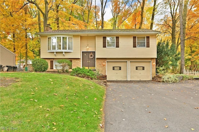 bi-level home featuring a front lawn and a garage