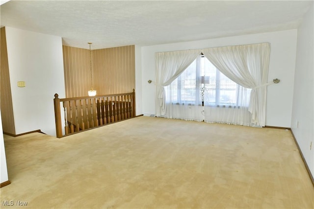 carpeted spare room with a textured ceiling