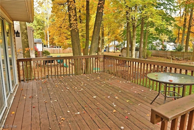 wooden deck with a storage shed