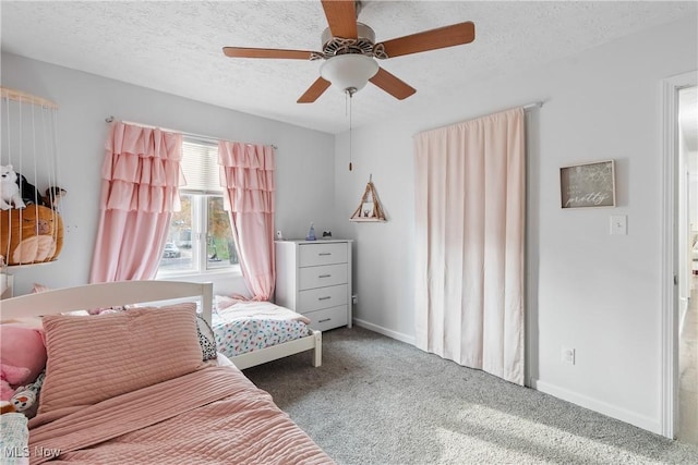 bedroom featuring carpet flooring, ceiling fan, and a textured ceiling