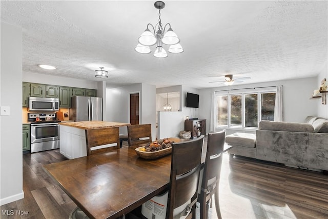 dining room featuring dark hardwood / wood-style floors, a textured ceiling, and ceiling fan with notable chandelier