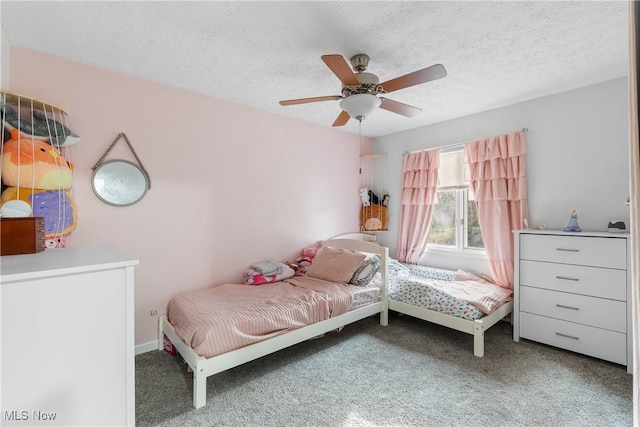 carpeted bedroom featuring a textured ceiling and ceiling fan